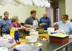 Volunteers in Tell City prepare the weekly dinner they serve to people in need at “Table of Blessings,” a program of Catholic Charities Tell City that is supported by the “United Catholic Appeal: Christ Our Hope.” (Submitted photo)