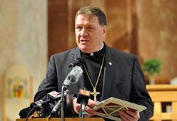 Archbishop Joseph W. Tobin, greets the media during an Oct. 18 press conference at SS. Peter and Paul Cathedral in Indianapolis. Archdiocesan priests, men and women religious, lay employees and area Catholics also attended the press conference. (Photo by Mary Ann Garber)