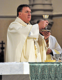 Archbishop Joseph W. Tobin elevates a chalice during an Oct. 20 Mass at St. John the Evangelist Church in Indianapolis. Archbishop Tobin was introduced on Oct. 18 at SS. Peter and Paul Cathedral in Indianapolis as the new shepherd of the Church in central and southern Indiana. (Photo by Sean Gallagher)