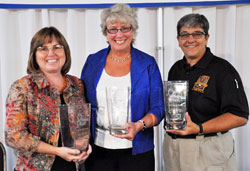 Angels of Grace award recipient Sally Schrock, left, a member of Carmel United Methodist Church in Carmel, Ind., and founder of Second Starts, poses for a photo with award recipients Bonnie Schott of St. Roch Parish in Indianapolis and Indianapolis Metropolitan Police Department Sgt. Jo Ann Moore, a member of Our Lady of the Greenwood Parish in Greenwood, after the fifth annual Benedict Inn Retreat and Conference Center fundraiser on Sept. 29 at Primo Banquet Hall in Indianapolis. The luncheon, style show and awards program were presented by the Sisters of St. Benedict of Our Lady of Grace Monastery in Beech Grove as a way to honor women who help others through distinguished volunteer service that benefits their church and community. (Photo by Mary Ann Garber)