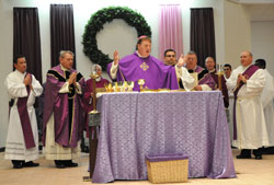 Archdiocesan priests and deacons join Archbishop Joseph W. Tobin, the principal celebrant, during a Mass for the first Sunday of Advent on Dec. 1 at Our Lady of the Greenwood Church in Greenwood. Msgr. Mark Svarczkopf, second from left, pastor of the Indianapolis South Deanery parish, was one of the concelebrants. (Photo by Mary Ann Garber)