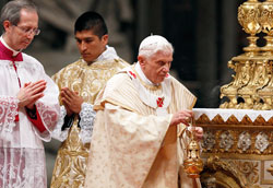 Pope Benedict XVI uses incense as he celebrates Christmas Eve Mass in St. Peter’s Basilica at the Vatican on Dec. 24. Pontifical North American College seminarian Martin Rodriguez of Indianapolis, center, served during the liturgy. (CNS photo/Paul Haring)