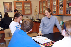 Bishop Chatard High School teacher Stephanie Theis shares a fun moment with senior Maggie McNelis and other students during a biology class. Besides teaching and coaching at the Indianapolis North Deanery interparochial school, Theis also volunteers at Brooke’s Place, an organization that provides support and services to grieving children and their families. (Photo by Michael Sahm)