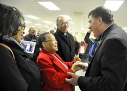 Anita Bardo, left, Mary Guynn and Charles Guynn, all members of St. Rita Parish in Indianapolis, greet Archbishop Joseph W. Tobin during a reception following a Feb. 5 Mass at St. Therese of the Infant Jesus (Little Flower) Church in Indianapolis. Mary Guynn, a mother of 21 children, is the great aunt of Anita and Charles. (Photo by Sean Gallagher)