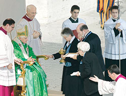 Providence Sister Denise Wilkinson, general superior of the Sisters of Providence of Saint Mary-of-the-Woods, Philip McCord and Providence Sister Marie Kevin Tighe offer gifts to Pope Benedict XVI during the canonization liturgy for four saints, including Blessed Mother Theodore Guérin, on Oct. 15, 2006, at St. Peter’s Square in Rome. (Photo by Kelly Wilkinson/The Indianapolis Star)