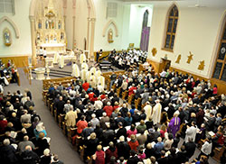 Catholics from across southeastern Indiana fill St. Louis Church in Batesville on Feb. 19 as Archbishop Joseph W. Tobin and several priests and deacons who minister in the Batesville Deanery process into the church at the start of a welcome Mass with Catholics from the deanery and the recently installed archbishop. (Photo by Sean Gallagher)
