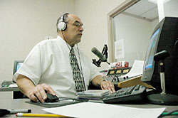 In this file photo, Jim Ganley, station manager of Catholic Radio Indy 89.1 and 90.9 FM, works in the station’s production studio in Indianapolis. Catholic radio stations across central and southern Indiana continue to be an effective tool of evangelization. (File photo by Sean Gallagher)