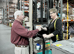 Bill Grote, left, chats on May 13 with Debbie Randall in a Grote Industries factory in Madison. Grote is chairman of the board of the family-owned business. Randall has worked there for more than 30 years. (Photo by Sean Gallagher)