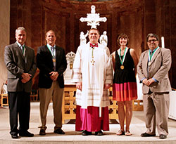 Four of the 2013 St. John Bosco Award recipients pose for a photograph with Archbishop Joseph W. Tobin during the Catholic Youth Organization Volunteer Awards Ceremony on May 7 at SS. Peter and Paul Cathedral in Indianapolis. They are, from left, Phil Kenney, Paul Weaver, Sandy Clegg and Tom Hayes. The fifth recipient, Mary Jo Reed, wasn’t able to attend the ceremony because she was traveling out-of-state. (Photo by Jennifer Peterson)