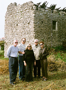 Father Louis Manna, fourth from left, stands with family and friends in front of an Italian vacation home in Agerola, Italy, that needs a little work. (Submitted photo)