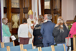 Archbishop Joseph W. Tobin greets attendees of the National Catholic Council on Addictions workshop after a special Mass for them at SS. Peter and Paul Cathedral in Indianapolis on April 29. (Photo by Natalie Hoefer)