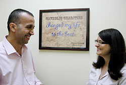 A refugee from Iraq, Basim Najeeb, left, has not only made a new life in Indianapolis with the help of Catholic Charities Indianapolis, he also helps new refugees through his work with the archdiocese’s Refugee Resettlement Program. Here, he talks with Teresa Jones, match grant coordinator for the Refugee Resettlement Program. (Photo by John Shaughnessy)