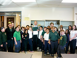 Attorney Michael Paton is surrounded by students as he serves as “Principal for a Day” at Holy Cross Central School in Indianapolis. (Submitted photo)