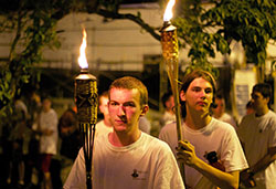 John Paul Cole, left, and Alex Jackson, participants in the Bishop Bruté Days vocations camp, carry torches during a eucharistic procession on June 12. (Photos by Charles Peñalosa)
