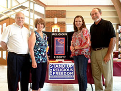 Members of the St. Barnabas Religious Liberty Action Committee pose on June 9 in front of a booth run by the committee in the narthex of St. Barnabas Church in Indianapolis. The members are, from left, Dave and Jean Webb, Julie Oelker and Chuck Stumpf. (Submitted photo)