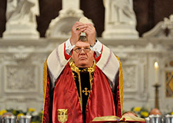 Archbishop Joseph W. Tobin elevates the Eucharist during his installation Mass on Dec. 3, 2012, at SS. Peter and Paul Cathedral in Indianapolis. He will receive his pallium from Pope Francis during a special Mass at St. Peter’s Basilica at the Vatican on June 29. (File photo by Mary Ann Garber)