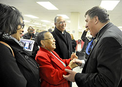 Anita Bardo, left, Mary Guynn and Charles Guynn, all members of St. Rita Parish in Indianapolis, greet Archbishop Joseph W. Tobin during a reception following a Feb. 5 Mass at St. Therese of the Infant Jesus (Little Flower) Church in Indianapolis. Mary Guynn, a mother of 21 children, is the mother of Charles and the great aunt of Anita. (File photo by Sean Gallagher)