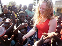 In this Jan. 20 photo, Alexandra “Alex” Servie is greeted by children at a Radio Pacis event in a village near Arua, Uganda. (Submitted photo)