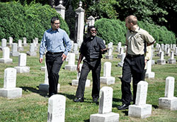 Seminarian Rafael Quintero, left, transitional Deacon Xavier Raj Yeusudason and seminarian Kyle Rodden walk together on Aug. 14 in the cemetery of the Sisters of Providence of Saint-Mary-of-the-Woods. (Photo by Sean Gallagher)