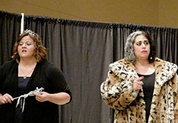 Megan Gehrich, left, plays the role of the Fairy Godmother and Ashley Rutherford depicts Cruella De Vil in a scene from a murder mystery dinner show at St. Mary Parish in Greensburg that raised $1,500 to help teenagers attend the National Catholic Youth Conference in Indianapolis on Nov. 21-23. (Submitted photo)