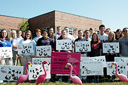 Pink flamingos and cows have helped the youths of St. Mark and St. Roch parishes in Indianapolis raise money to attend the National Catholic Youth Conference in Indianapolis on Nov. 21-23. St. Mark teenagers placed flocks of flamingoes in people’s yards as birthday greetings and good-natured pranks while St. Roch youths achieved the same effects with a herd of cows. (Photo by John Shaughnessy)