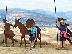 Ann Tully, right, and Carolyn Webster, recently traveled to France and Spain to walk along the ancient pilgrimage path known as ‘The Way.” Here, they pose for a photo by the Alto del Perdon, the “Mount of Forgiveness,” a sculpture dedicated to the pilgrims who travel the path that leads to the shrine of St. James at Santiago de Compostela in Spain. (Submitted photo)