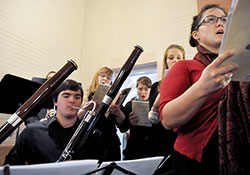 Instrumentalists and vocalists play and sing Wolfgang Amadeus Mozart’s Requiem Mass in D minor during a Nov. 2 All Souls Day Mass at Our Lady of the Most Holy Rosary Church in Indianapolis. Owen Carlos, left, a music student at Butler University in Indianapolis, plays the bassoon, while Ann Lewis, Andrea Stanley, Noelle Brown and Alison Gudan, all Holy Rosary parishioners, sing. (Photo by Sean Gallagher)