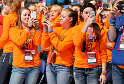 NCYC participants from the Diocese of Dodge City, Kan., take photos on Nov. 22 of the 23,000 youths gathered in Lucas Oil Stadium in Indianapolis listening to a presentation by Bob Herron, director of youth and young adult ministry for the Diocese of Wheeling-Charleston, W. Va. (Photo by Sean Gallagher)