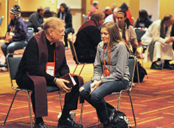 Father Rick Ginther, pastor of St. Patrick and St. Margaret Mary parishes, both in Terre Haute, hears the confession of a National Catholic Youth Conference participant on Nov. 22 in the Indiana Convention Center in Indianapolis. (Photo by Sean Gallagher)