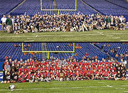 Top: The football team of Cathedral High School in Indianapolis poses with the Indiana High School Athletic Association Class 5A trophy after its 42-18 victory in the state championship game on Nov. 29 at Lucas Oil Stadium in Indianapolis. (Submitted photo by Rolly Landeros) Bottom: The football team of Cardinal Ritter Jr./Sr. High School in Indianapolis poses with the Indiana High School Athletic Association Class 2A trophy after its 56-6 win in the state championship game on Nov. 30 at Lucas Oil Stadium in Indianapolis. (Submitted photo by Joe DeFabis)