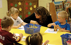 The archdiocese’s superintendent of Catholic schools Gina Fleming listens as kindergarten students Tori Benyon and Connor Baldwin of St. Rose of Lima School in Franklin share their reasons for why they appreciate their school. Fleming has made it her goal to visit all 68 Catholic schools during this school year to learn what makes them special. (Submitted photo)