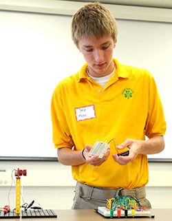 Sophomore Skip Maas of Shawe Memorial Jr./Sr. High School in Madison explains a project he did with a circuit board during a STEM roundtable program at Shawe on Oct. 9, 2013. (Photo by Ken Ritchie, provided by The Madison Courier )