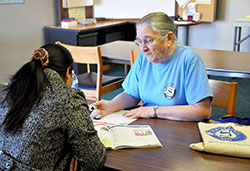 RSVP volunteer Carolyn Crowell teaches English to a Burmese refugee on Feb. 10. RSVP is a clearinghouse of volunteer opportunities for those ages 55 and older. (Photo by Natalie Hoefer)