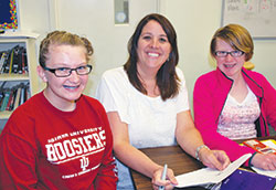 A teacher at St. Mary School in North Vernon, Lisa Vogel is the recipient of the 2014 Distinguished Teacher Award from the National Catholic Educational Association. Here, she pauses for a photo with two of her seventh-grade students, Allison Short, left, and Macy Diekhoff. (Submitted photo)