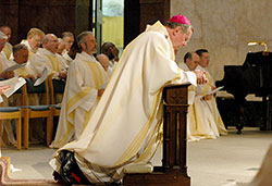 Archbishop Daniel M. Buechlein kneels in prayer during a June 7, 2007, priesthood ordination Mass in SS. Peter and Paul Cathedral in Indianapolis. (File photo by Sean Gallagher)