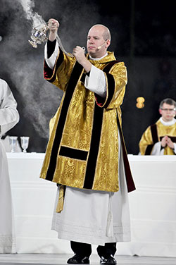 Transitional Deacon Timothy Wyciskalla incenses the congregation at the closing Mass for the National Catholic Youth Conference at Lucas Oil Stadium in Indianapolis on Nov. 23, 2013. He will be ordained a priest on June 7 at SS. Peter and Paul Cathedral in Indianapolis. (File photo by Sean Gallagher)