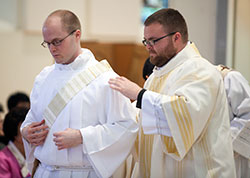 In this April 6, 2013, photo, transitional Deacon David Marcotte is vested by his brother, Doug—also a transitional deacon at the time—during a diaconate ordination in the Archabbey Church of Our Lady of Einsiedeln in St. Meinrad. Deacons Marcotte and Bedel will be ordained priests on June 7 at SS. Peter and Paul Cathedral in Indianapolis. (Photo courtesy of Saint Meinrad Seminary and School of Theology)