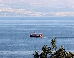 A boat makes its way across the Sea of Galilee. Those who join the archdiocesan pilgrimage to the Holy Land in February of 2015 will take an excursion in a boat on the Sea of Galilee. (Photo by Carolyn Noone)
