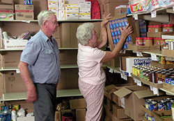 In this 2009 photo, Leroy and Marlene Oser, members of St. Martin of Tours Parish in Siberia, work at Martin’s Cloak, a Tell City Deanery food pantry that is partially funded by money raised through the United Catholic Appeal: Christ Our Hope annual campaign. (Submitted photo)