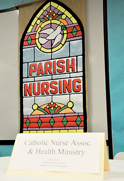 A banner hangs in a resource room at a recent parish nursing retreat. Parish nursing, also known as health ministry, is a growing trend in parishes of central and southern Indiana. (Photo by Natalie Hoefer)