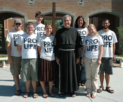 In this photo from July 21, 2007, Crossroads Pro-Life walkers pose at St. Michael the Archangel Church in Indianapolis. On July 24-27, Crossroads Pro-Life walkers will again be traveling through Indiana on foot along U.S. 40 in support of the pro-life cause, speaking at Masses and praying at an abortion center. Pictured are Jason Spoolstra of Fort Worth, Texas, left; Jason Handcock of Sacramento, Calif.; Beth Ann Flessner of Madison, Miss.; Tina Hardy of Buffalo, N.Y.; Franciscan Father Dan Pattee of Steubenville, Ohio; Cassandra Blanco of Deltona, Fla.; Alzbeta Voboril of Wichita, Kan.; and William Tolsma of Niles, Mich. (Criterion file photo)