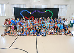 Youth participants and adult leaders of the vacation Bible School program “Walking in the Light of Christ” pose on June 29 at St. Paul School in New Alsace. Father Jonathan Meyer, pastor of All Saints Parish in Dearborn, which includes St. Paul School, helped develop the vacation Bible school program with the assistance of a team of youth ministers, teachers and other adult volunteers. (Submitted photo)