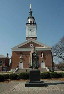 The Old Cathedral Basilica of St. Francis Xavier in Vincennes, Ind., is the oldest church in Indiana. Pilgrims from all over the world have visited the historic church. A statue of Father Pierre Gibault, vicar general of “the Illinois country,” who lived from 1737 to 1804, stands in front of the basilica. To mark the 180th anniversary of the founding of what is now known as the Archdiocese of Indianapolis, Archbishop Joseph W. Tobin will lead a one-day pilgrimage to Vincennes on Sept. 22.  (Criterion file photo)