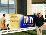 Men in front of sign