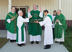 Bishop Christoper J. Coyne blesses the new food pantry building at SS. Francis and Clare of Assisi Church in Greenwood in this Sept. 7 photo. Assisting him are SS. Francis and Clare associate pastor Father David Marcotte, left, Deacon Steven Hodges, Deacon Ronald Pirau, altar server Christina Sluka and SS. Francis and Clare pastor Father Vincent Lampert. (Photo submitted by SSFC Media Group)