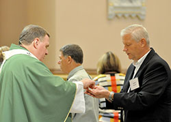 David Thomas, a member of Holy Spirit Parish of Indianapolis, receives the Eucharist from Archbishop Joseph W. Tobin on Sept. 17 at SS. Peter and Paul Cathedral in Indianapolis at a Mass held for those considering joining or renewing their membership in the Miter Society— those who donate $1,500 or more to the “United Catholic Appeal: Christ Our Hope” annual appeal. (Photo by Natalie Hoefer)