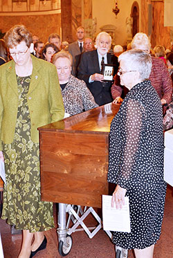 Providence Sisters Dawn Tomaszewski, left, Mary Beth Klingel, Lisa Stallings (partially obscured) and general superior Sister Denise Wilkinson process with the remains of St. Mother Theodore Guérin on Oct. 3 from the Church of the Immaculate Conception at Saint Mary-of-the-Woods to the saint’s new permanent shrine connected to the church by a hallway. The open house for the new shrine is from 1-4 p.m. on Oct. 25. (Submitted photo)