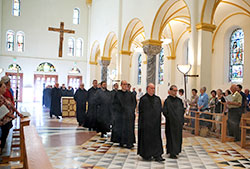 With guests looking on, monks of Saint Meinrad Archabbey in St. Meinrad process into their Archabbey Church of Our Lady of Einsiedeln. For centuries, the monastic life has offered its own unique gifts to the service of the Church and the world. (Photo courtesy of Saint Meinrad Archabbey)