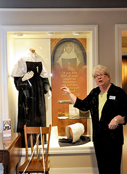 Providence Sister Jan Craven, coordinator of the Shrine of Saint Mother Theodore Guérin, describes the replica of the saint’s habit during the shrine’s open house on Oct. 25. (Photo by Natalie Hoefer)