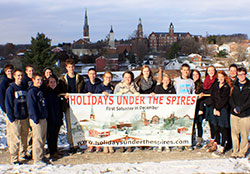Students at Oldenburg Academy of the Immaculate Conception in Oldenburg display the banner they created to promote the community’s annual “Holidays Under the Spires” event on Dec. 6. Members of the school’s National Business Honor Society took the lead this year in planning and promoting the village’s Christmas celebration. (Submitted photo)